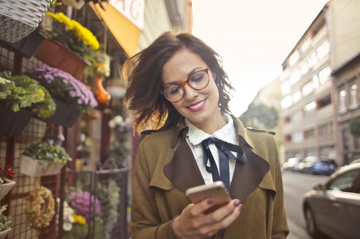 woman-beside-flower-shop-using-smartphone-3772531-min-min (2)